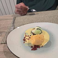 Orange ice cream with a mocha in a pear cream sauce