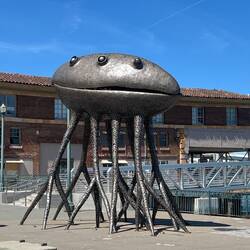 Corpus is a 16-to-22-foot tall, salvaged steel crab or alien sculpture by artist Michael Christian.