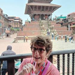 Anna sharing a mango smoothie at a cafe in a temple comples