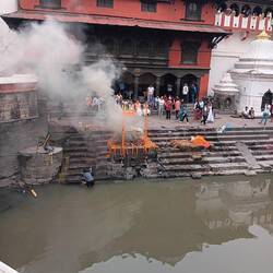 Cremation on the banks of the river Bagwati with marigolds