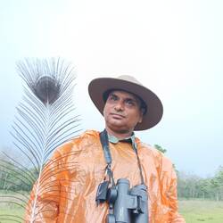 Our naturalist, Kamal, with peacock feather