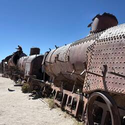 Heaping hulks of rusted metal stretch along abandoned tracks at the Uyani Train Graveyard.