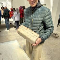 Michael holds a heavy salt brick--the building blocks in this place of no trees.