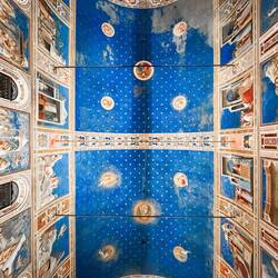 The barrel-vaulted blue ceiling is studded with painted stars — Scrovegni Chapel.