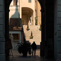 Peeking through the arched entry into the lower courtyard of Palazzo Moroni — Padova, Italy.