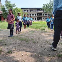 Primary school children doing exercises and singing patriotic songs