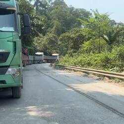 A long queue of parked trucks transporting minerals for export snaked its way up to the checkpoint.