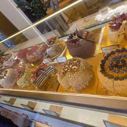 Stopped at a coffee shop for coffee and found these beautiful cakes sold by weight.