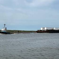 Tug pulling a barge