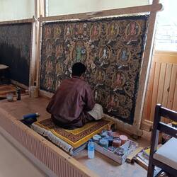 A thangka painter.  Highly detailed, usually geometric, paintings.