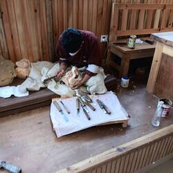 Wood carver working on a mask