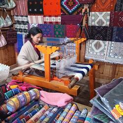 Woman weaving table runners in her tourist stall.  We bought two the next day.