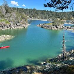 View on the hike, looking into Smugglers Cove. Mike on his Kaboat.