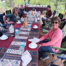 Anna at our ourdoor lunch with handwoven table runner.
