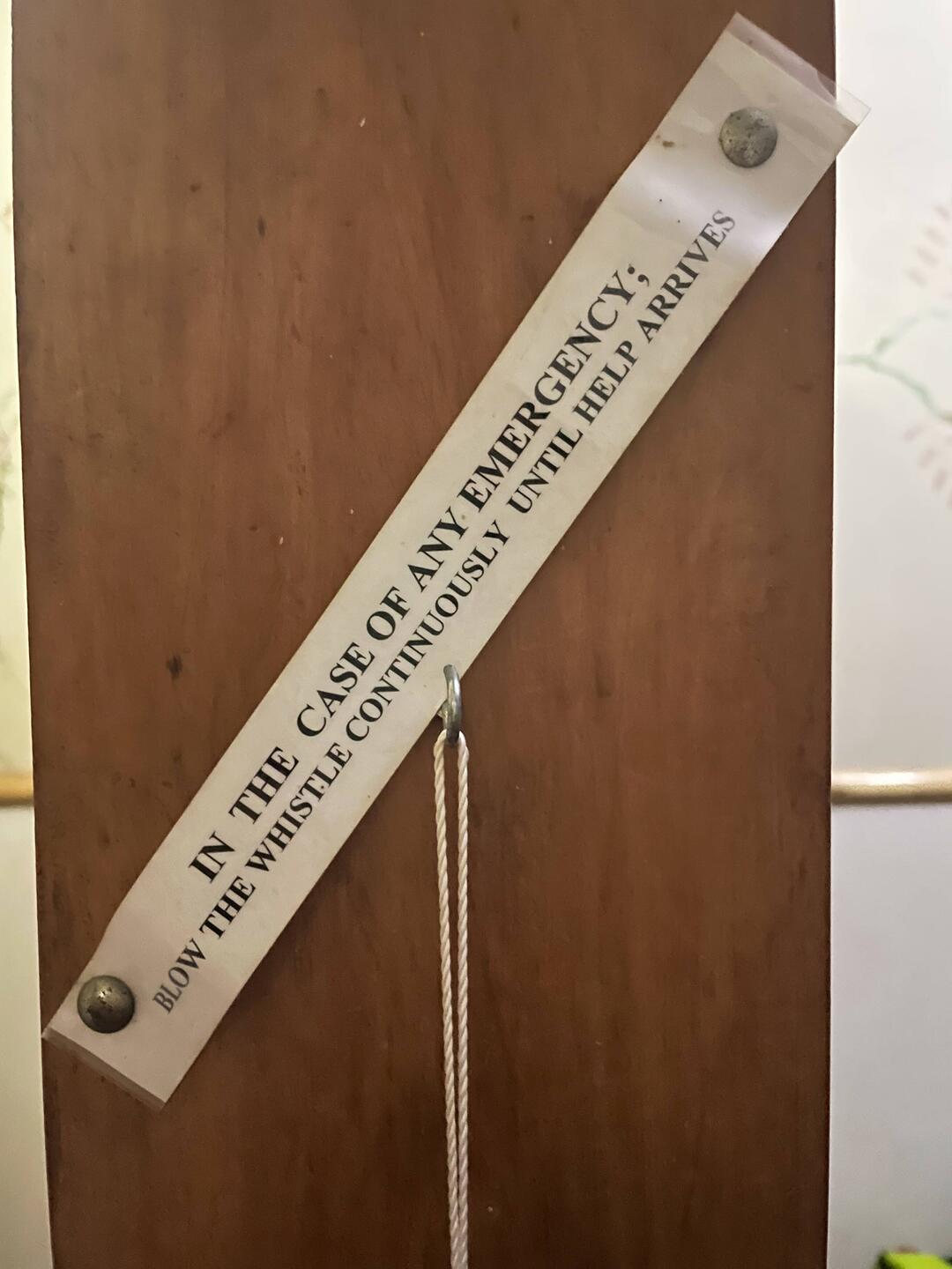 A whistle hangs beneath this sign in our room in the Luwawa Lodge:)