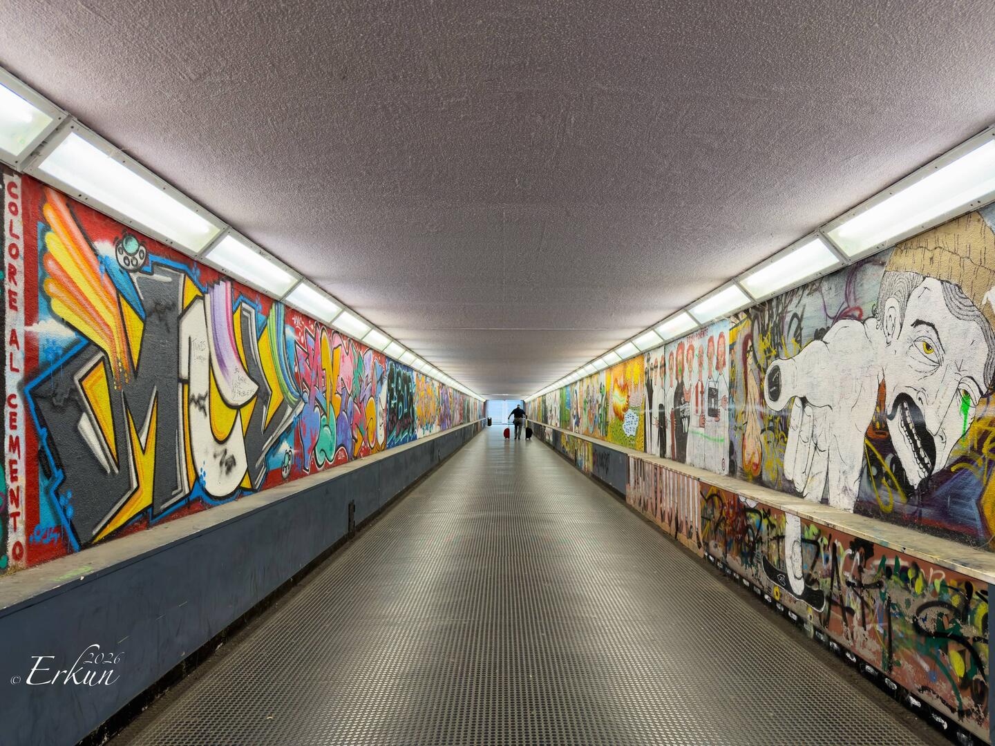 Mural and graffiti-decorated underground passage to the Autostazione — Ravenna, Italy.