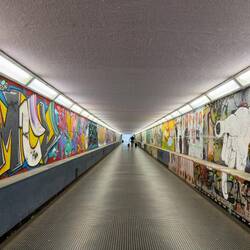 Mural and graffiti-decorated underground passage to the Autostazione — Ravenna, Italy.