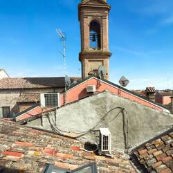 Bell tower of the Church of the Carmine from the stairs at our hotel — Comacchio, Italy.