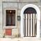 Shade curtain in the doorway ... we saw a lot of these all around town — Comacchio, Italy