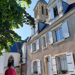 Delightful windows in the village of Vouvray, with the Cathedral clock in the background