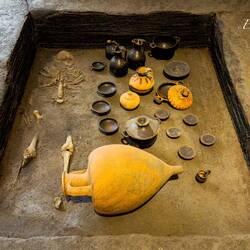 Tomb 125D: skeletal remains; grave goods, incl. transport amphora (typical of 4th cent. funerals)