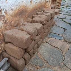 Adobe bricks on display. The home is built of timbers and adobe bricks