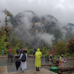 Rainy weather on the way down. Tiger's Nest framed by wisps of clouds