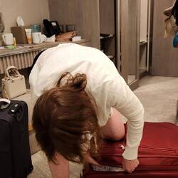 Laura trying to close her suitcase