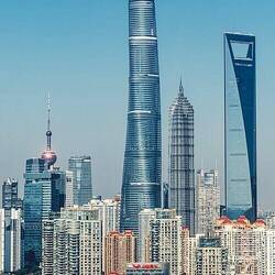 Shanghai Tower on left, "The Bottle Opener" on right. Some guy climbed the middle bldg w/o equipment