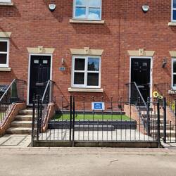Illegal 'No Mooring' signs on the railings of new build houses near Hyde