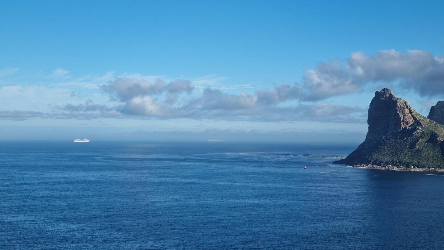 Sentinel Peak looms above the sealed colony at Hout Bay. The ship is the one we'll be boarding.