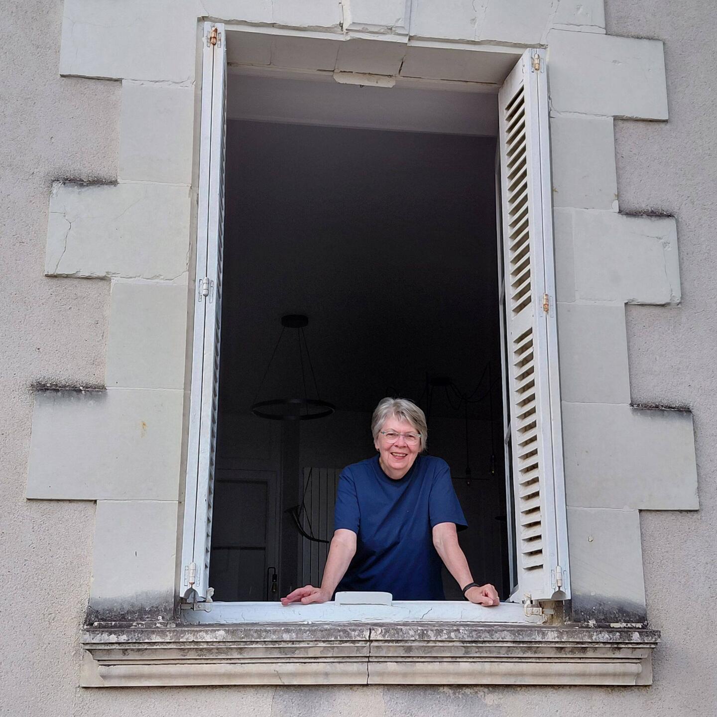 Elaine checking out the passing parade from our living room window