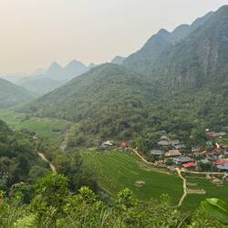 The road dropped steeply. We stood high above traditional Thai stilt houses dotting the valley below