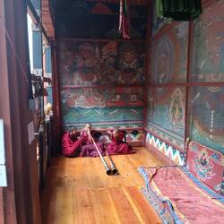 Young monks learning to play a musical horn