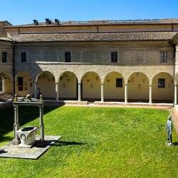 Statues of St Chiara (L) and St Francis of Assisi ... in the cloister at Museo Dante.