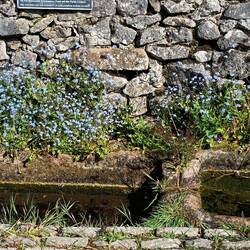 Water troughs in Chelmorton with signage explaining the challenges of water supply in past centuries