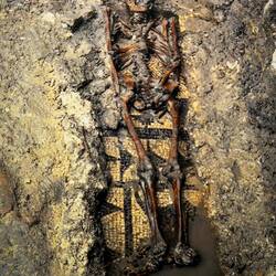 Grave 32: one of several unearthed during excavations; note mosaic floor under the skeletal remains.
