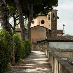 The path down to Fontana Ardea Purpurea continues behind the church — Ravenna, Italy.