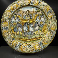 Emperor's triumphant return; prisoners in shackles; soldiers on horseback (17th century Majolica).