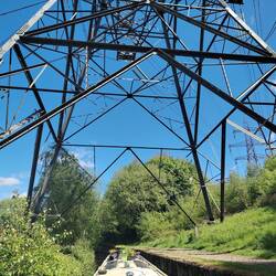 Rainboat between the pylon legs