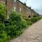 This cobbled street held mill workers' cottages complete with Topshop for home working