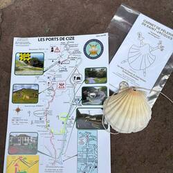 Map (with helpful pictures!), pilgrim passport, and the traditional shell for the backpack.