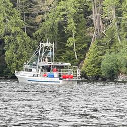 Fishing boat in Kwatsi Bay setting prawn traps.
