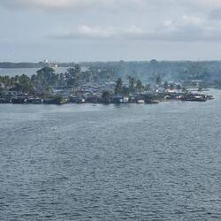 Fishing village across the lagoon from modern Abidjan. The smoke is fish smoking.