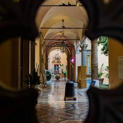 Loggia through the wrought-iron gate ... Palazzo Boncompagni — Bologna, Italy.