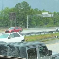 The white car hydroplaned and hit the guardrail.