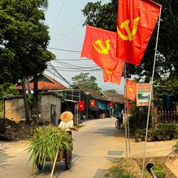 Proudly they display their flag and the communist hammer and sickle