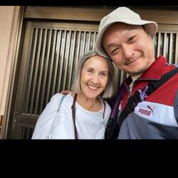 With landlord Yusuke Morita in front of his property