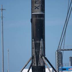 Notice the people standing underneath the rocket.
