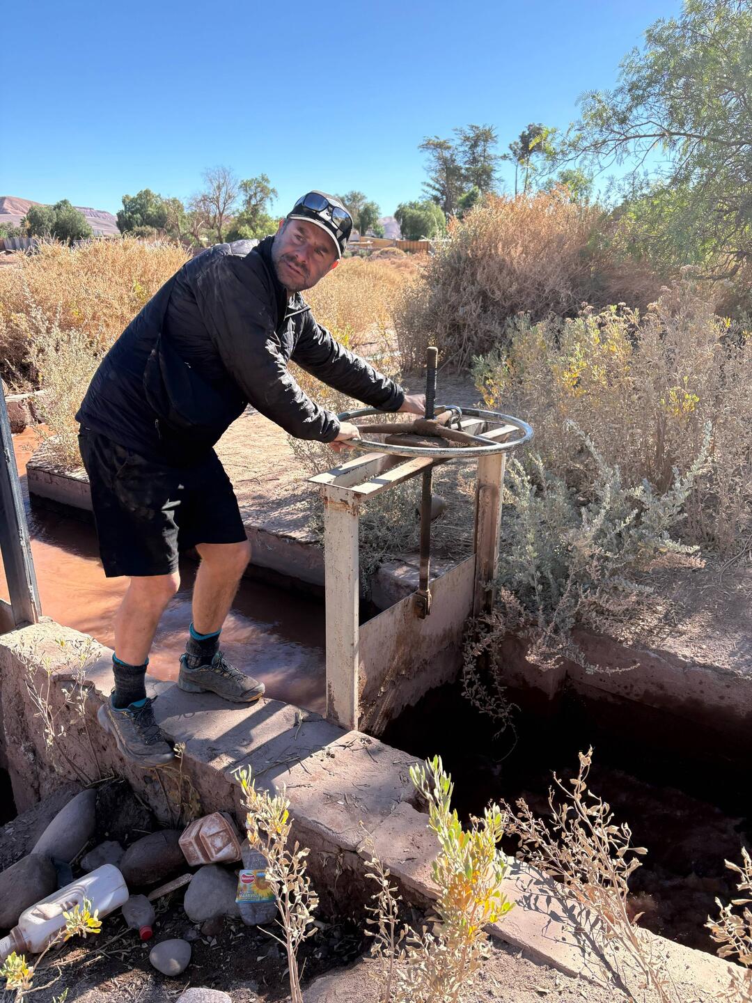 Our local guide Cristóbal explains how irrigation gates work in the desert